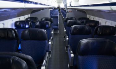 American Airlines is dropping its first class cabins for more business class seats. Pictured are first and economy class cabins of an American Airlines aircraft at Dallas/Fort Worth International Airport on September 1