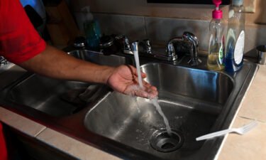 Timbo Payne checks the water pressure in his kitchen at his home on September 3 in Jackson