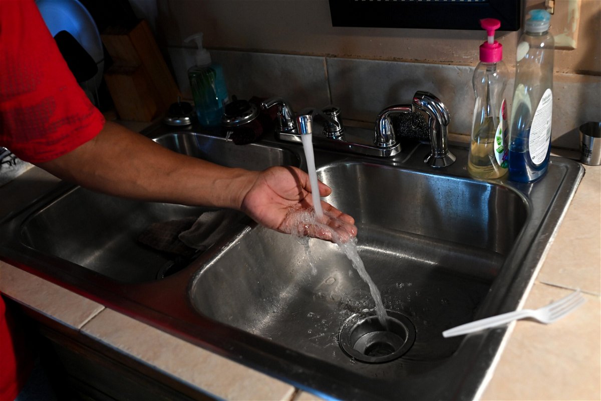 <i>Joshua Lott/The Washington Post/Getty Images</i><br/>Timbo Payne checks the water pressure in his kitchen at his home on September 3 in Jackson