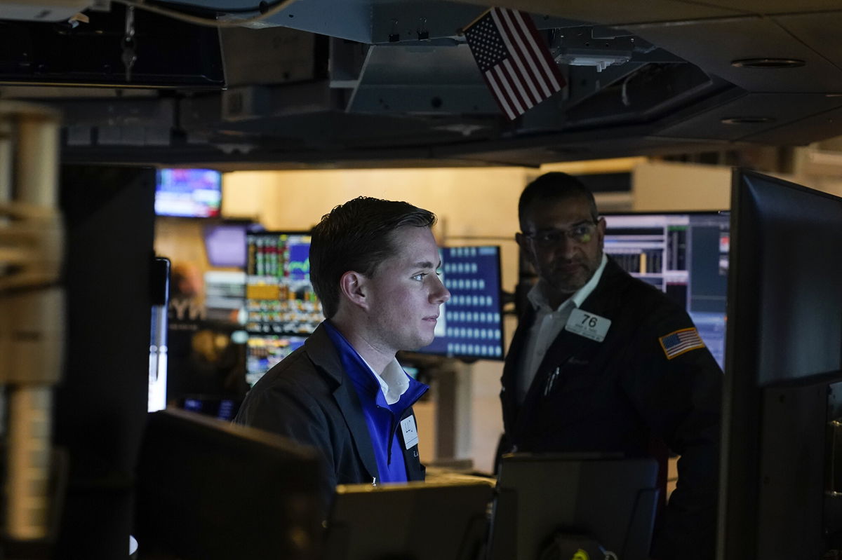 <i>Seth Wenig/AP</i><br/>Stocks are up modestly so far on Tuesday. Traders work on the floor at the New York Stock Exchange