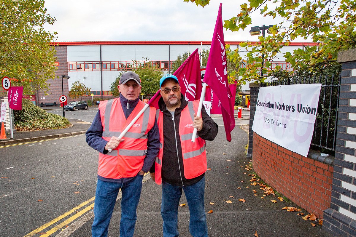 <i>Gustavo Pantano/Spotlight Images/Shutterstock</i><br/>Royal Mail workers are seen on strike at the main entrance of Wolverhampton Royal Mail Center on October 13.