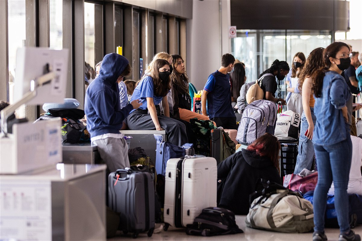 <i>Jeenah Moon/Getty Images</i><br/>Major US airlines are criticizing the Biden administration's latest plans to publicize flight delay compensation. Travelers here wait at Newark Liberty International Airport on July 1