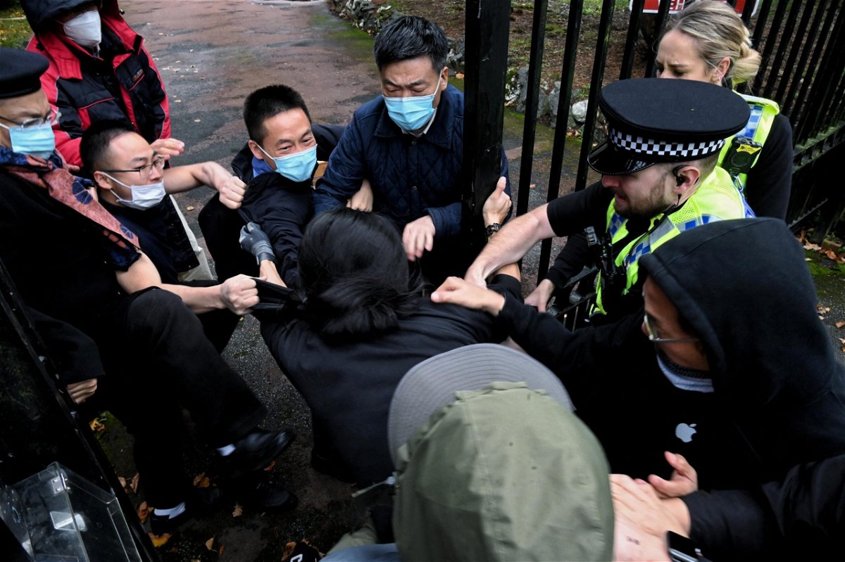 <i>Matthew Leung/The Chaser News/Reuters</i><br/>A man is pulled at the gate of the Chinese consulate after a demonstration against China's President Xi Jinping
