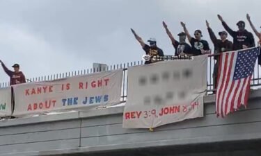 A photograph shared on the verified campaign Twitter account of Los Angeles mayoral candidate Karen Bass shows a group of demonstrators with banners showing support for rapper Kanye West's recent antisemitic remarks on a Los Angeles freeway overpass Saturday. CNN has blurred a portion of the image that included a reference to a website with antisemitic content.