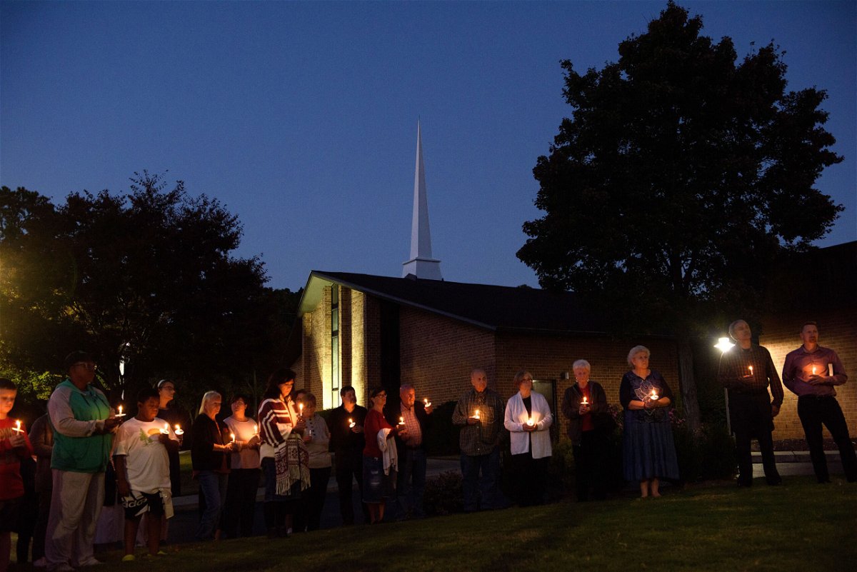 <i>Melissa Sue Gerrits/Getty Images</i><br/>Mourners gather at Beacon Baptist Church for a vigil after five people were gunned down in Raleigh