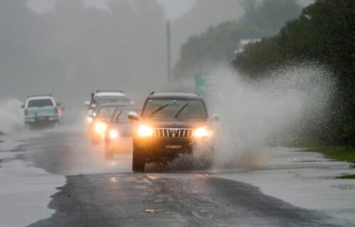 Cars drive through flood waters in Richmond on the outskirts of Sydney