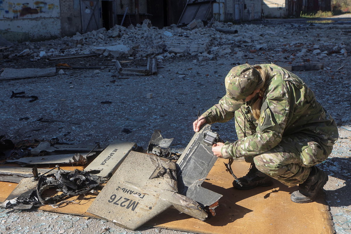 <i>Vyacheslav Madiyevskyy/Reuters</i><br/>A police officer inspects parts of an unmanned aerial vehicle