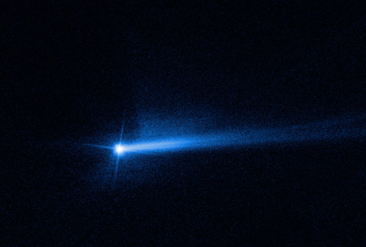 <i>NASA/ESA/STScI/Jian-Yang Li (PSI)</i><br/>Two tails of dust ejected from the Didymos-Dimorphos asteroid system are visible in an image from the Hubble Space Telescope