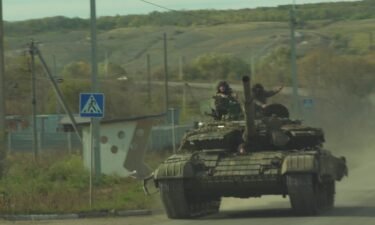 A Ukrainian tank drives past our convoy on the way out of Bakhmut.