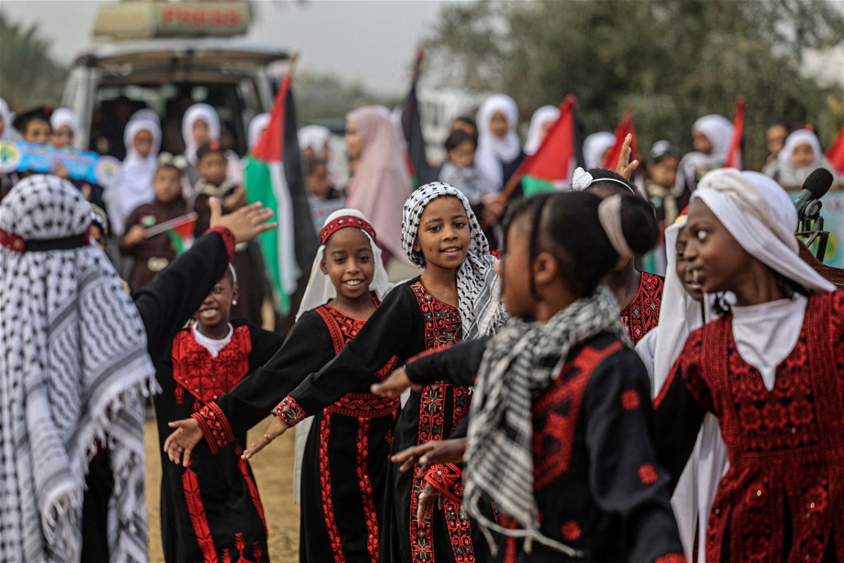 <i>Said Khatib/AFP/Getty Images</i><br/>Palestinian girls wearing traditional embroidered dresses perform during a ceremony marking the start of the olive harvest season in Deir al-Balah in central Gaza on Sunday.