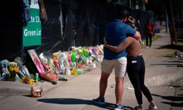 Two friends of a victim of the fatal crowd surge at the Astroworld Festival embraced at a Houston memorial on November 7