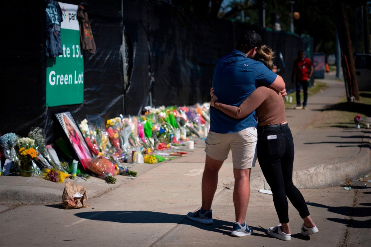 <i>Robert Bumsted/AP</i><br/>Two friends of a victim of the fatal crowd surge at the Astroworld Festival embraced at a Houston memorial on November 7