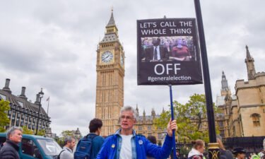 A protester holds a placard calling for a general election during the demonstration in Parliament Square in London