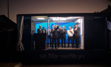 Former Israeli Prime Minster and Likud party leader Benjamin Netanyahu (center) speaks to supporters in a modified truck during a campaign event on October 6 in Hadera