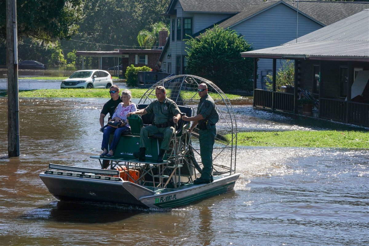 <i>Bryan R. Smith/AFP/Getty Images</i><br/>Osceloa County Sheriffs use a fanboat to rescue a 93-year-old resident from flooding on September 30 in Kissimmee