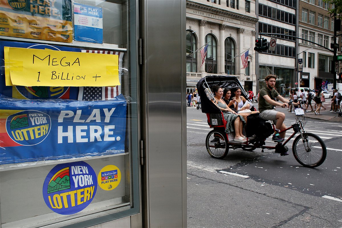 <i>John Smith/VIEWpress/Corbis/Getty Images</i><br/>A pedicab rides past advertisements for the Powerball lottery on July 29 in New York. The Halloween Powerball drawing offers the ultimate treat: an estimated $1 billion jackpot.