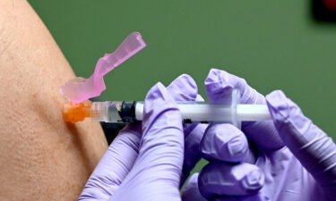A man gets a flu shot at a health facility in Washington