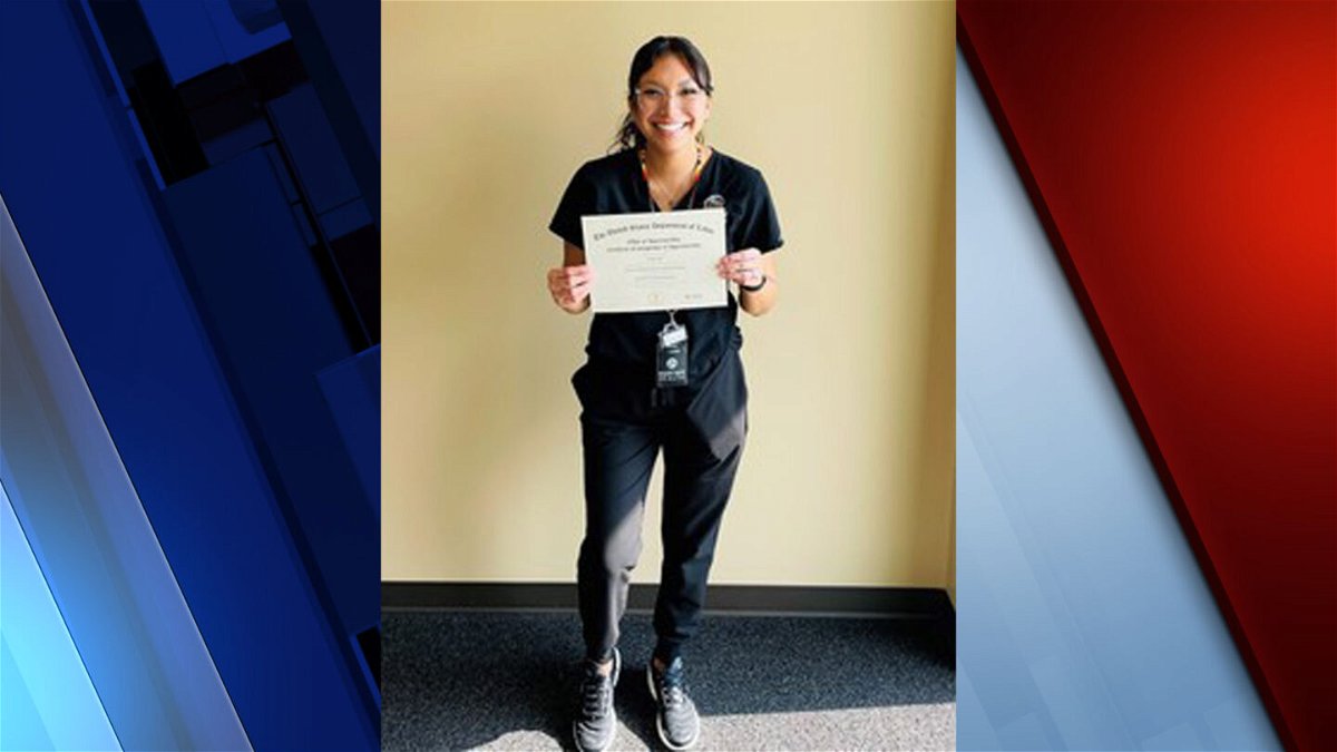 Mariah Aripa holds her dental assisting apprenticeship completion certificate. 