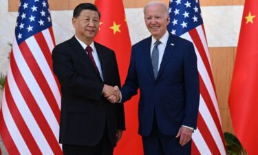 President Joe Biden (R) and China's President Xi Jinping shakes hands as they meet on the sidelines of the G20 Summit in Bali