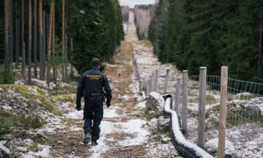 Senior border guard officer Juho Pellinen walks along a fence marking the boundary area between Finland and Russia on November 18. Finland has proposed to spend 139 million euros ($143 million) on building barrier fences on its eastern border with Russia in 2023.