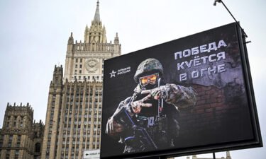 The Russian Foreign Ministry building is seen behind an advertising billboard showing the letter "Z" -- a tactical insignia of Russian troops in Ukraine -- and reading "Victory is being Forged in Fire" in central Moscow on October 13.