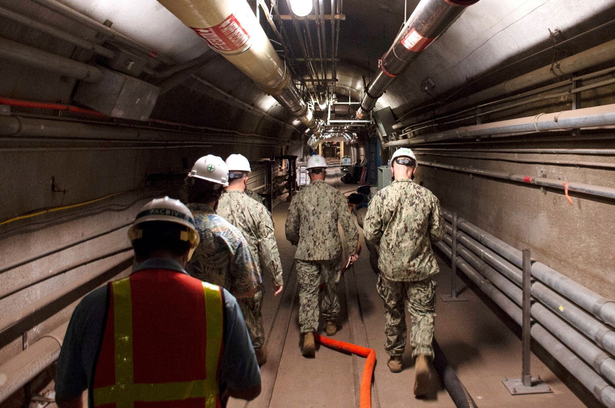 <i>Luke McCall/U.S. Navy/AP/FILE</i><br/>Water quality recovery experts are led through the tunnels of the Red Hill Bulk Fuel Storage Facility in Hawaii in December 2021. A lawsuit over Hawaii's Red Hill water contamination crisis has drawn in more than 100 new plaintiffs.