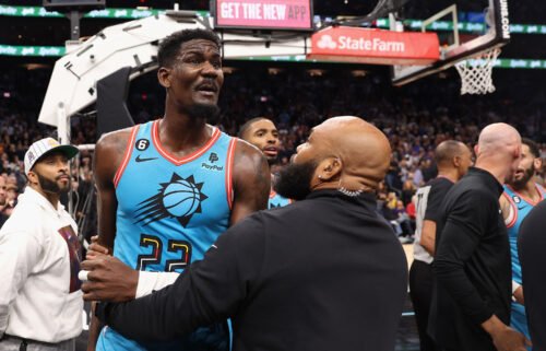 Deandre Ayton of the Phoenix Suns is restrained after being pushed to the court on November 22.