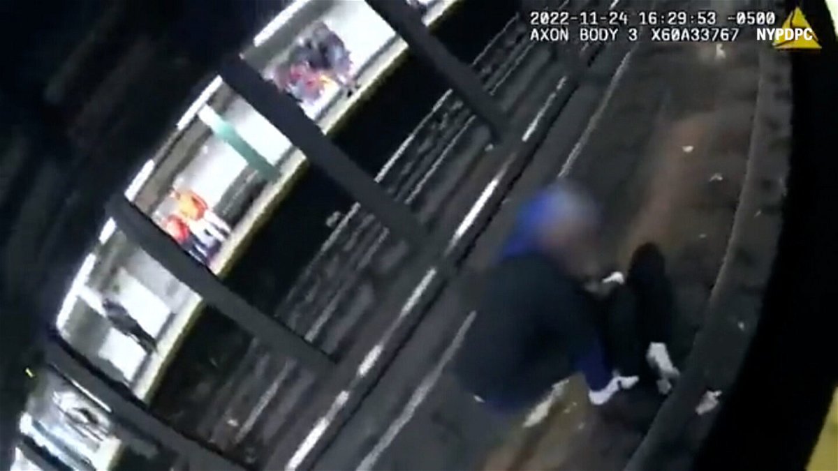 <i>NYPDPC</i><br/>Bodycam video released by authorities shows the good Samaritan trying to help the man on the tracks when officers arrived.