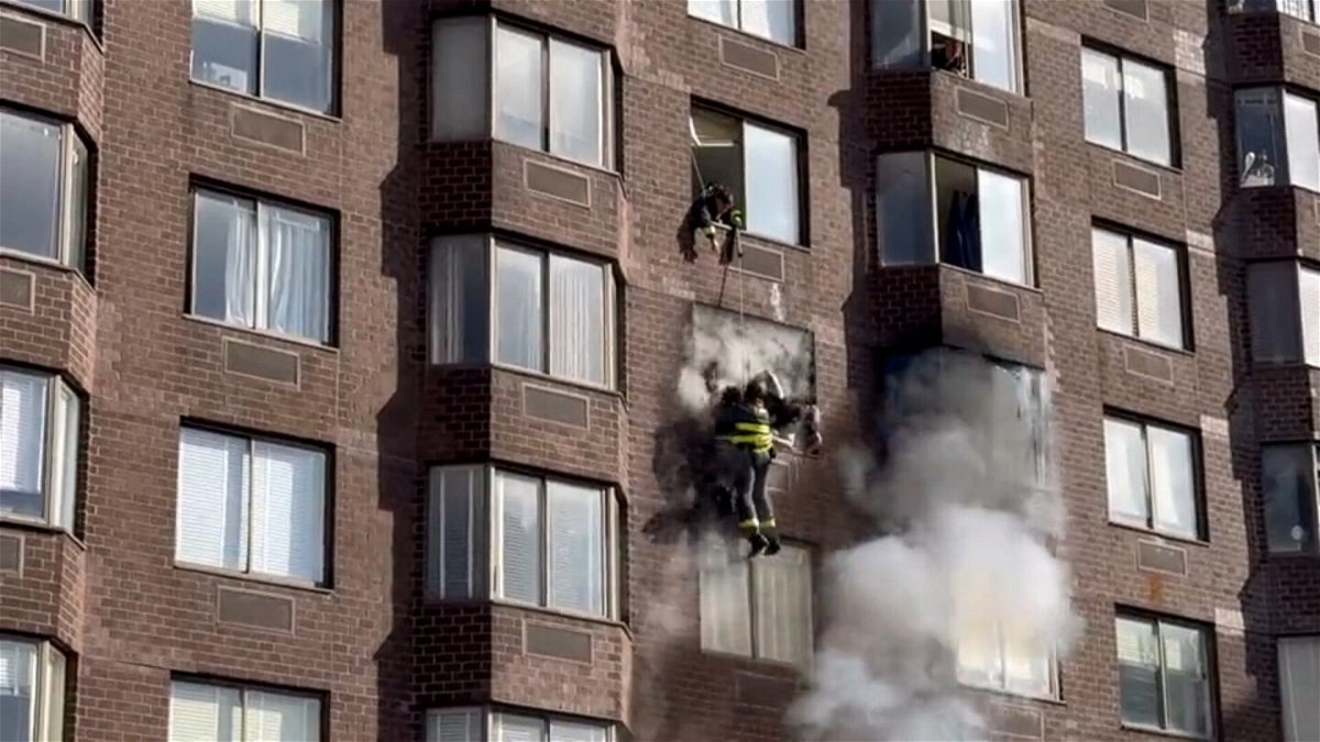 <i>Gregory Olkowicz</i><br/>Firefighters rescued a woman dangling from an apartment building in Manhattan where dozens were injured during a fire on Saturday