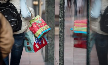 Inflation remains painfully high. A pedestrian carries Christmas themed bags in San Francisco
