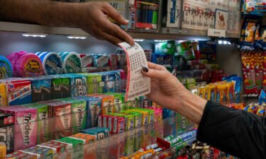 A person receives a lottery ticket for Powerball's 1.6 billion dollar jackpot in New York City on November 4.