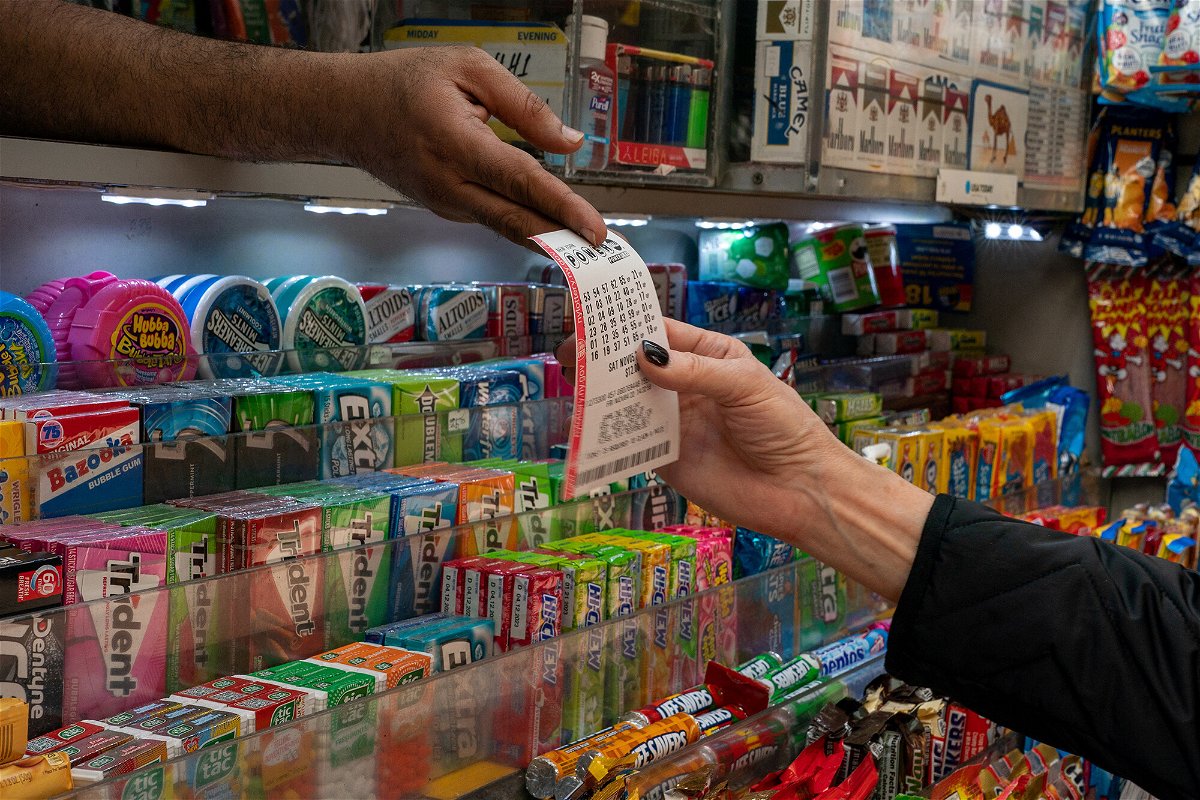 <i>David 'Dee' Delgado/Reuters</i><br/>A person receives a lottery ticket for Powerball's 1.6 billion dollar jackpot in New York City on November 4.