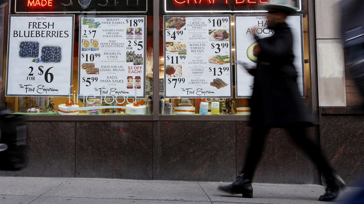 <i>Leonardo Munoz/VIEWpress/Getty Images</i><br/>A man walks past a market on November 10 in New York City. Inflation in New York City reportedly eased down to 6% over the past year