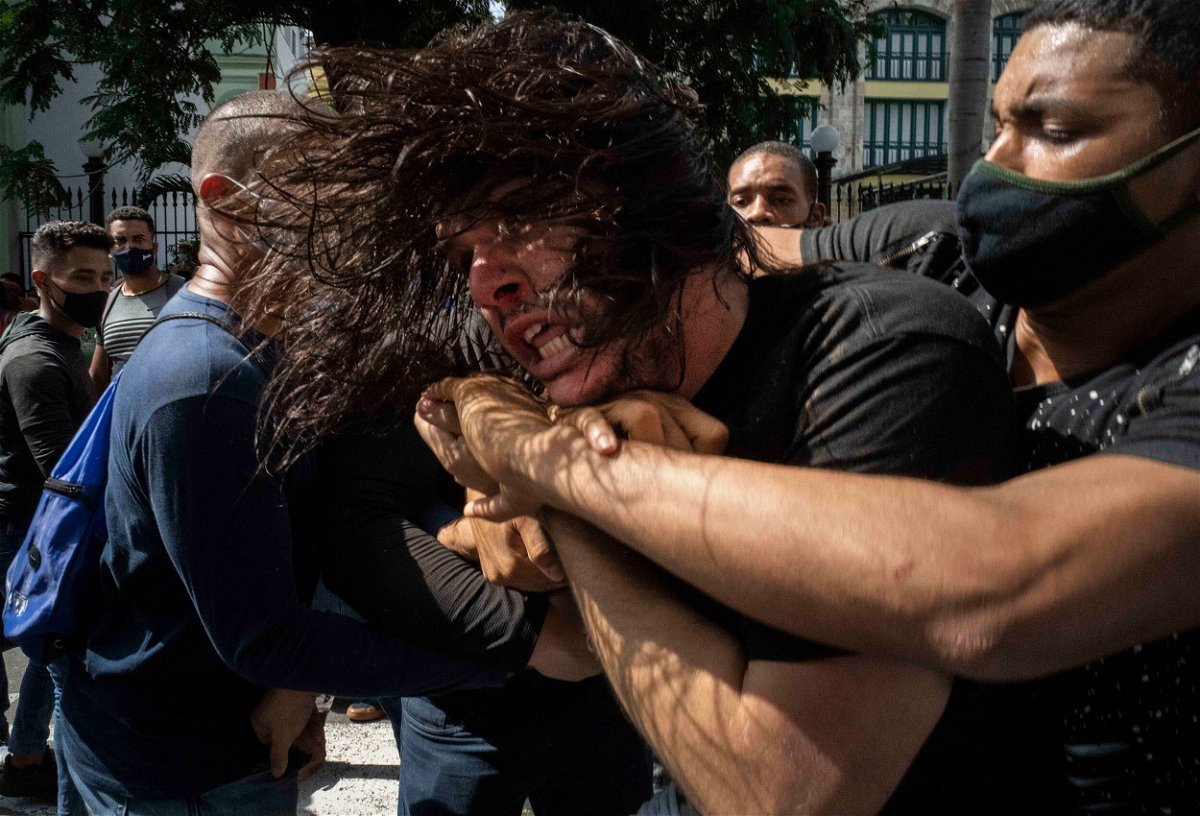 <i>Ramon Espinosa/AP</i><br/>Plainclothes police detain an anti-government protester during a protest in Havana