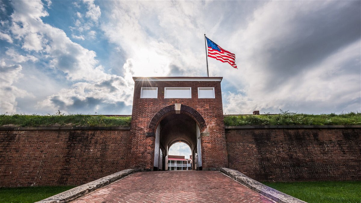 <i>Melissa Woolf/Adobe Stock</i><br/>Historic American flying over the entrance to Fort McHenry National Monument