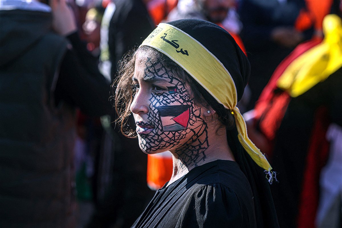 <i>Said Khatib/AFP/Getty Images</i><br/>A girl with face-paint depicting the Palestinian flag looks on as others gather with flags of the Fatah movement during a rally to commemorate the 18th anniversary of the death of Palestinian leader Yasser Arafat