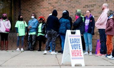 People line up outside a polling station to cast their vote on October 25 in Milwaukee. High inflation hardens some midterm election voters' party preferences.
