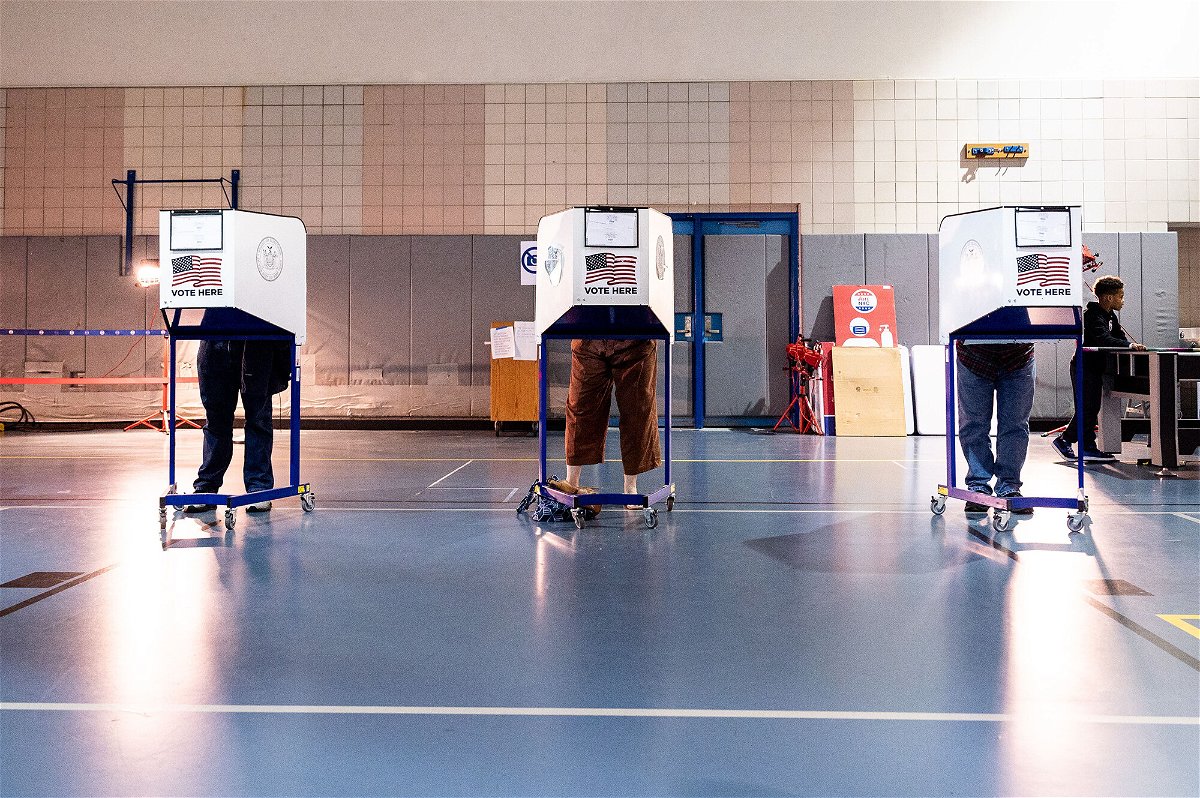 <i>Michael Brochstein/SOPA Images/Shutterstock</i><br/>Voters mark their ballot in a privacy booth at West Side High School during early voting in New York City