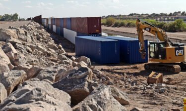Shipping containers block a void in the wall to stop migrants attempting to cross in to the U.S. from Mexico on August 19
