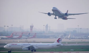 China has reduced the amount of time travelers entering the country must spend in quarantine and removed a major restriction on international flights. A China Eastern Airlines plane and Shanghai Airlines aircraft are seen in Shanghai in 2020.