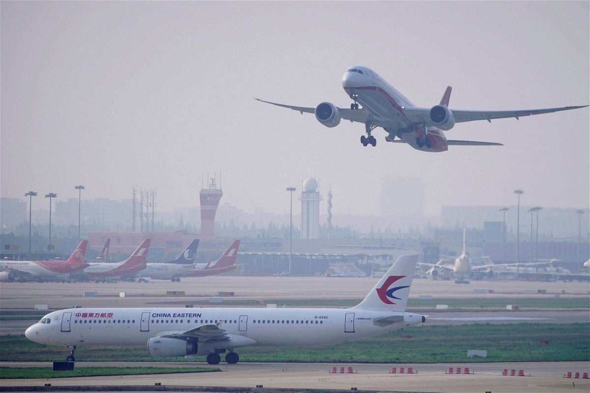 <i>Aly Song/Reuters</i><br/>China has reduced the amount of time travelers entering the country must spend in quarantine and removed a major restriction on international flights. A China Eastern Airlines plane and Shanghai Airlines aircraft are seen in Shanghai in 2020.