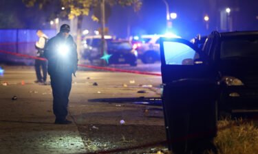 Police investigate at the scene of a drive-by shooting in Chicago Monday night.