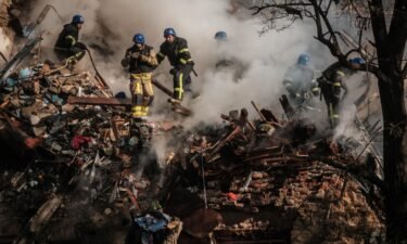 Ukrainian firefighters work on a destroyed building after a drone attack in Kyiv on October 17.