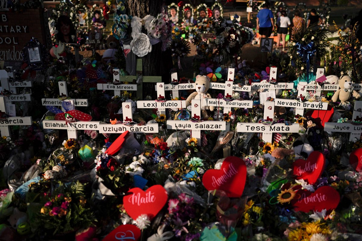 <i>Jae C. Hong/AP</i><br/>Flowers are piled around crosses remembering those killed at Robb Elementary School in Uvalde
