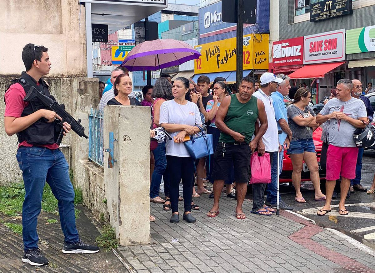 <i>Kadija Fernandes/AFP/Getty Images</i><br/>Local residents gather outside the police station where the alleged perpetrator of two school shootings is being held in Aracruz.