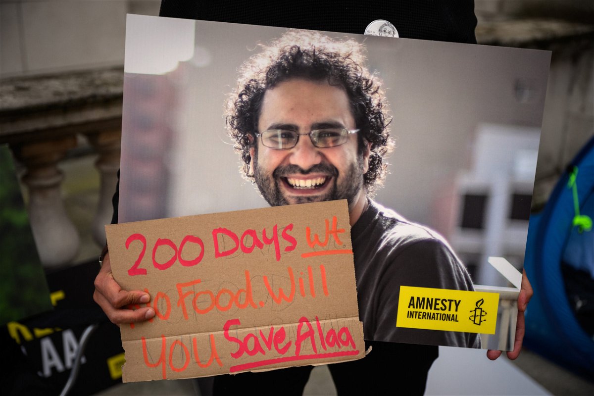 <i>Leon Neal/Getty Images</i><br/>A supporter holds a poster of Alaa Abd El-Fattah during a protest in London in October calling for his release.