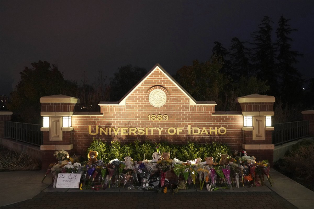 <i>Ted S. Warren/AP</i><br/>Flowers and other items are displayed at a growing memorial in front of a campus entrance sign for the University of Idaho