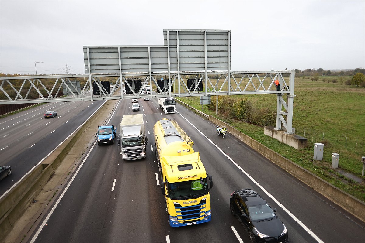 <i>Ben Cawthra/Shutterstock</i><br/>Activists from Just Stop Oil are pictured here climbing a gantry on the M25 highway near London Colney in Hertfordshire.