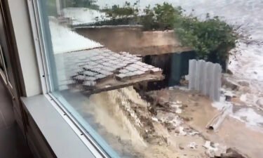 This image shows a bricked area outside a Florida home partially washed away