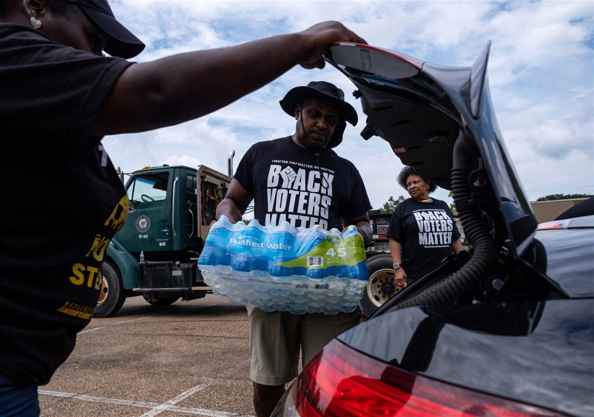 <i>Seth Herald/AFP/Getty Images</i><br/>Residents distribute cases of water last September in Jackson